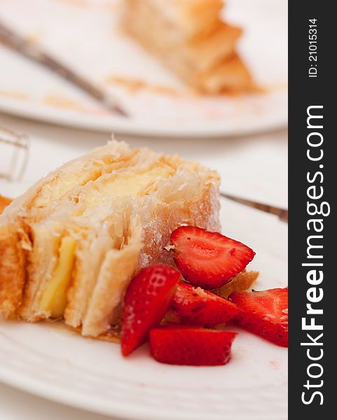 Portion of homemade cake, pastry cream and strawberries