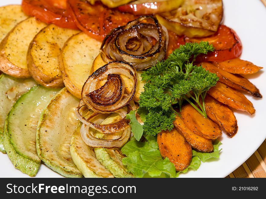 Baked vegetables on a plate. Vegetarian food.