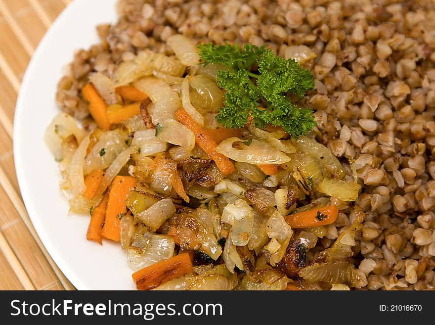 Buckwheat cereal with fried onions and carrots