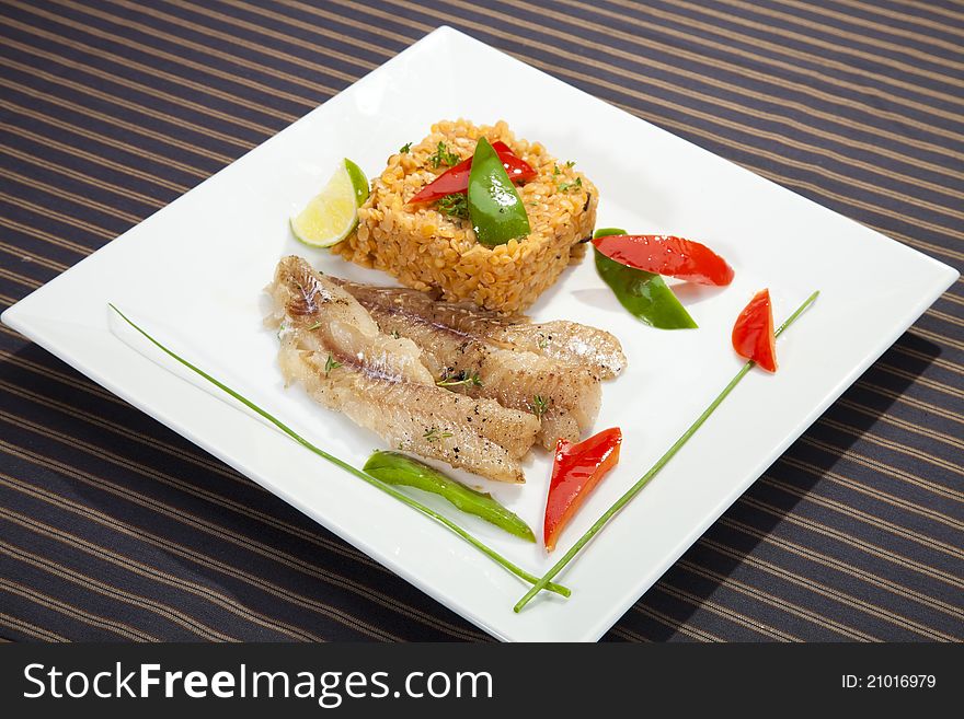 Grilled codfish with red lentil and bell pepper slices