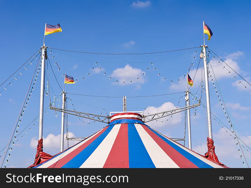 A circus tent with a blue sky in the background