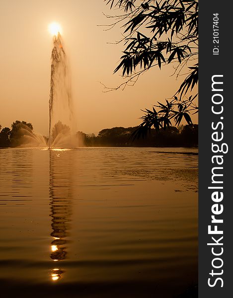 View of a fountain and water ripple with reflection on water surface. View of a fountain and water ripple with reflection on water surface