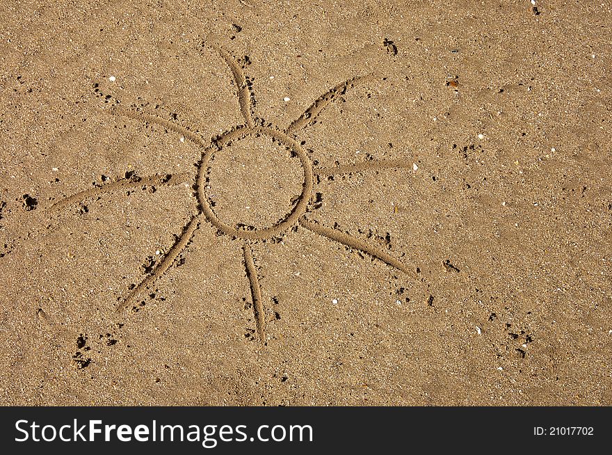 Children's drawing of the sun on sand