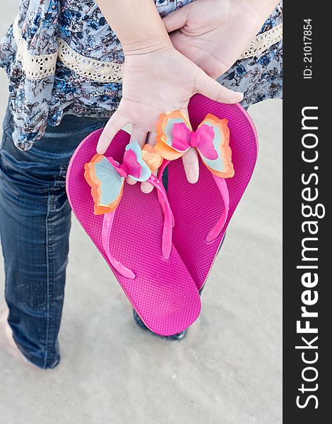 Young Woman On The Beach With Flip Flop