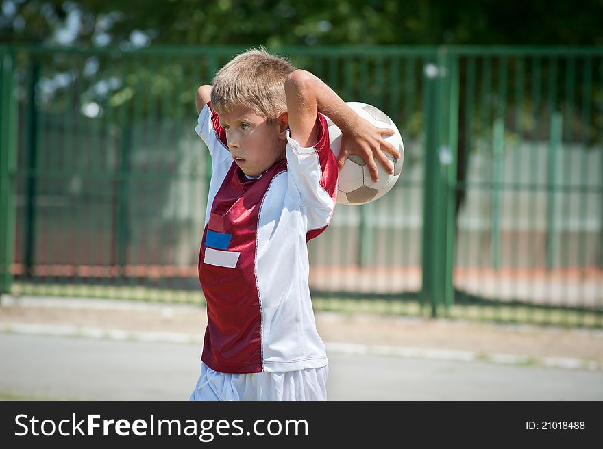 Boy throws the soccer ball