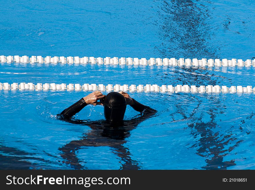 Man in diving equipment in the swimming pool. Man in diving equipment in the swimming pool