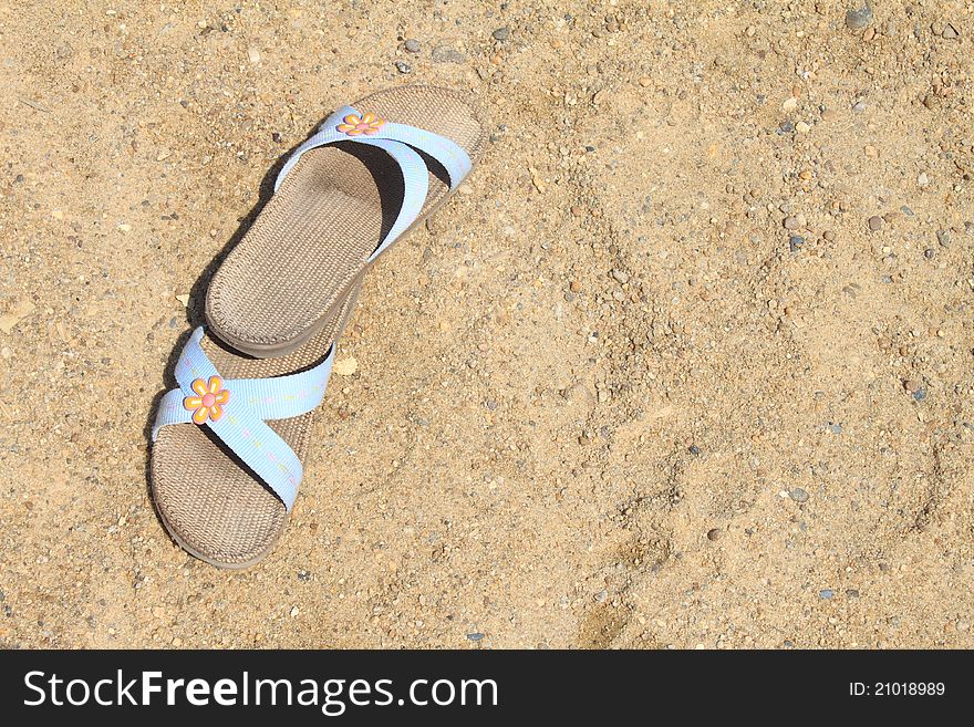 Flip-flop on sand in beach