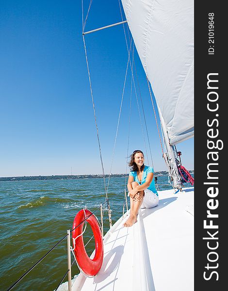 Young beautiful girl sitting on a yacht. Young beautiful girl sitting on a yacht