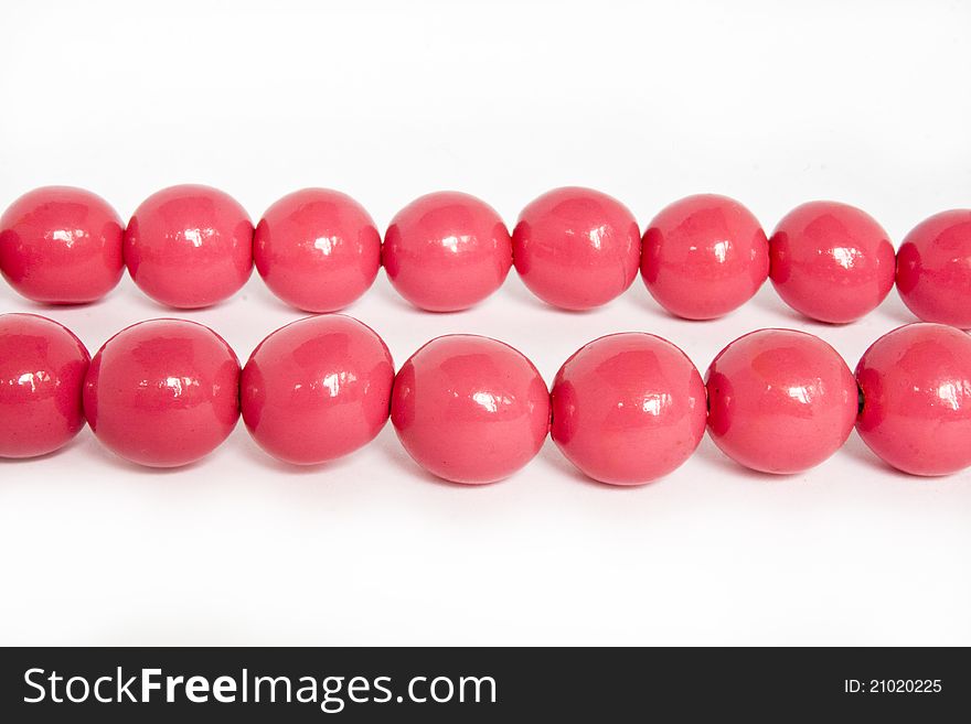 Pink beads on a white background