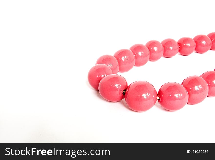 Curved pink beads on a white background