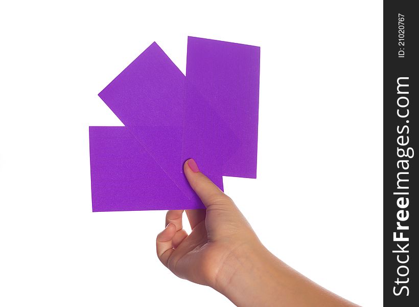 A hand holding three colorful paper index cards. A hand holding three colorful paper index cards