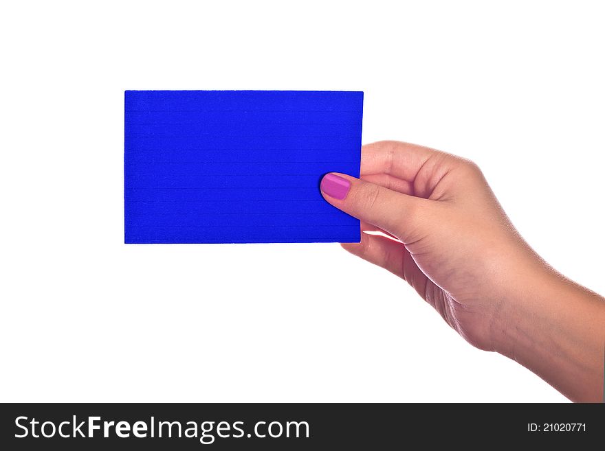 A hand holding a bright blue paper index card. A hand holding a bright blue paper index card