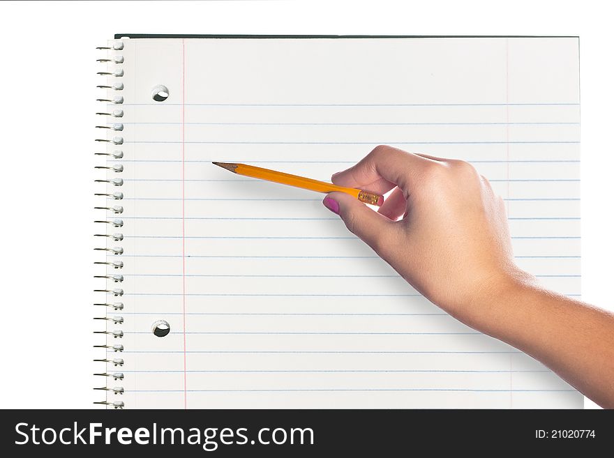 A hand holding a pencil over a blank page in a notebook. A hand holding a pencil over a blank page in a notebook