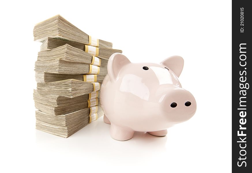 Pink Piggy Bank with Stacks of Hundreds of Dollars on a White Background. Pink Piggy Bank with Stacks of Hundreds of Dollars on a White Background.