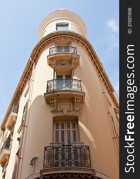 An elegant and ornate building in Monaco Ville, with balconies and stone carvings. An elegant and ornate building in Monaco Ville, with balconies and stone carvings