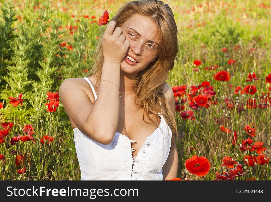 Portrait of a beautiful girl in the red poppies