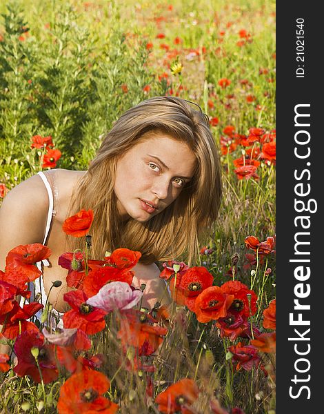 Portrait of a beautiful girl in the red poppies