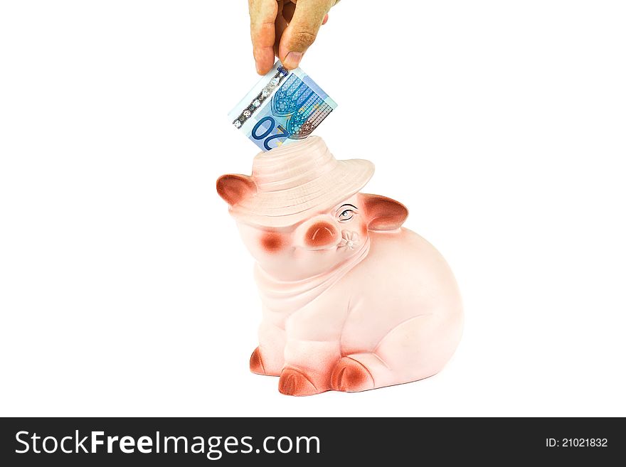 Male hand putting money into piggy bank