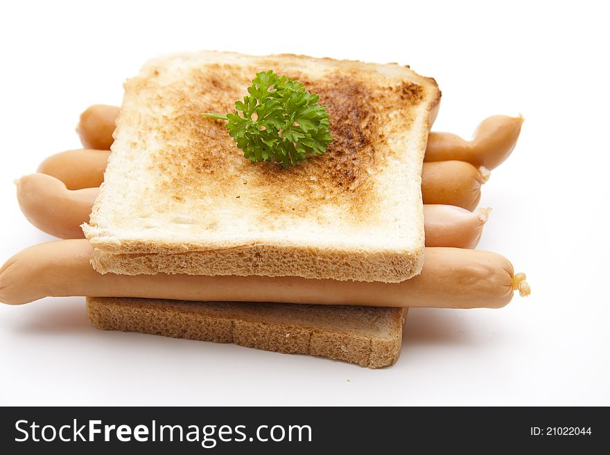 Frankfurter on toast bread with parsley on white background