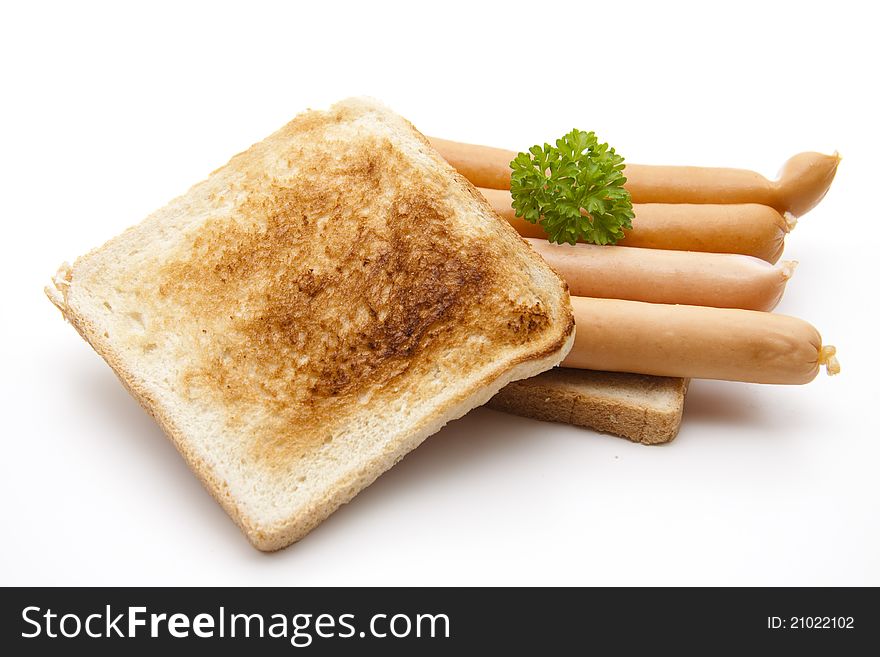 Frankfurter on toast bread with parsley on white background