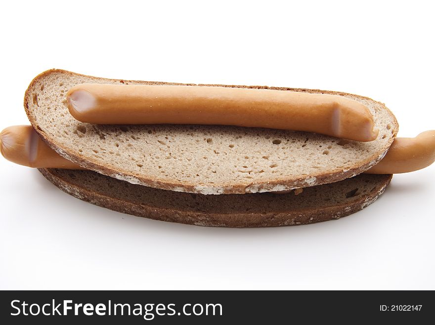 Frankfurter with bread on white background