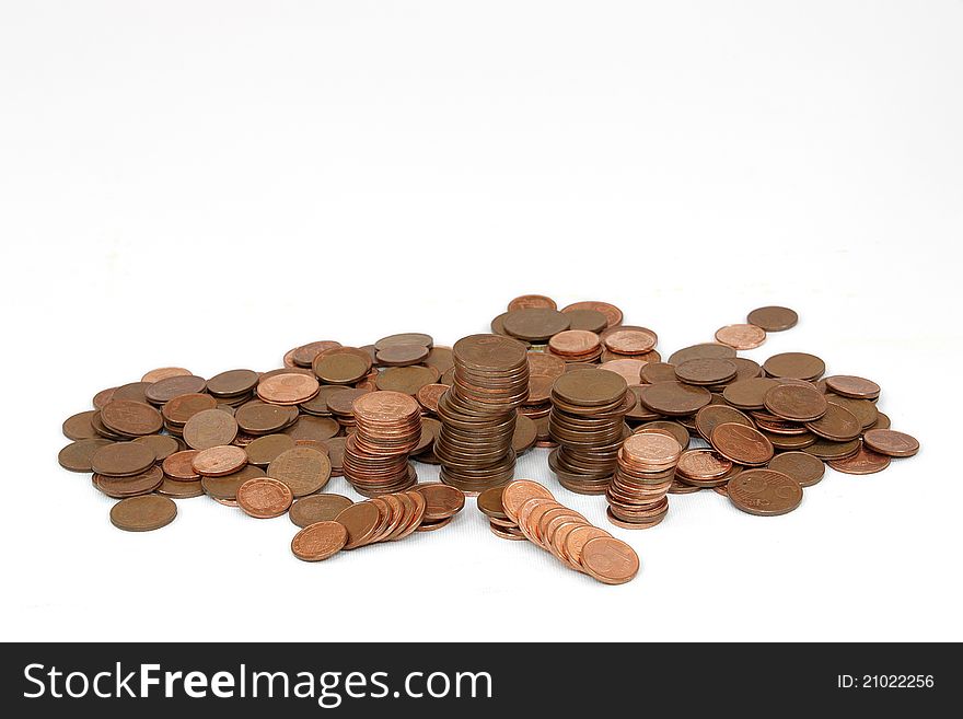 Copper coins of little value stacked on a white background. Copper coins of little value stacked on a white background