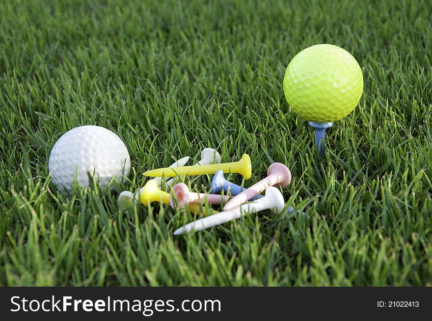 Balls of golf of colors together with his tees. Balls of golf of colors together with his tees.