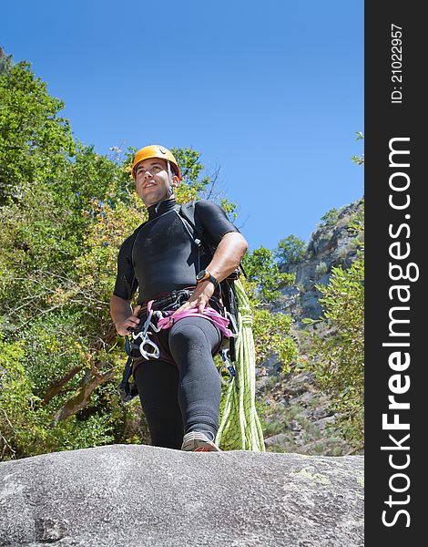 Men staring into horizont and prepering to rappeling into a canyon. Men staring into horizont and prepering to rappeling into a canyon