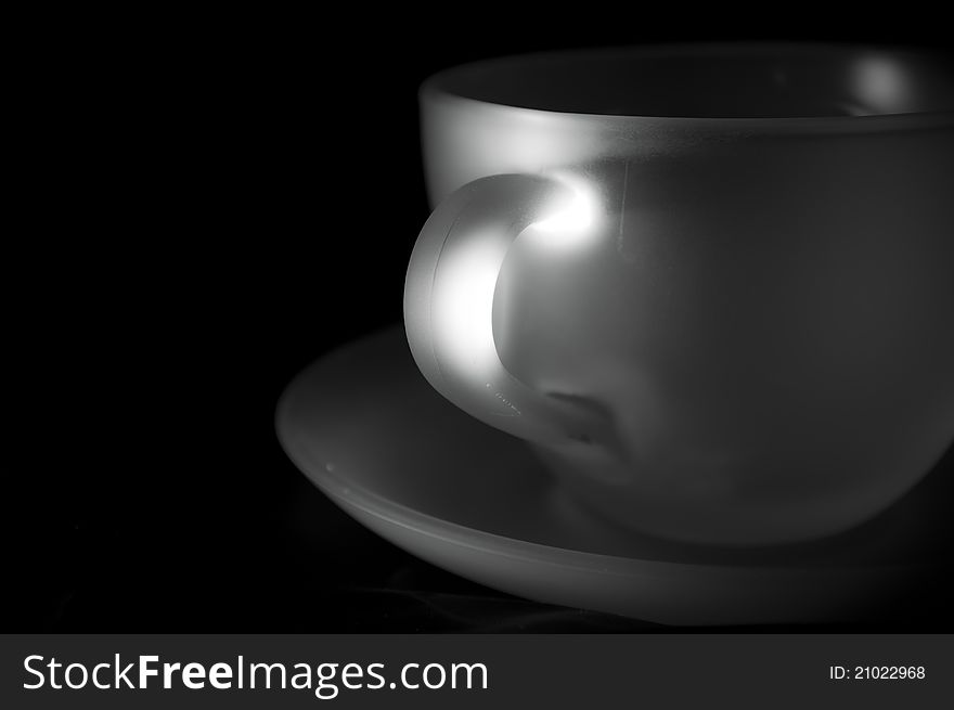 Light on white cup of tea