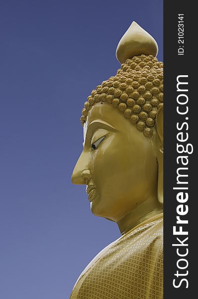 Goldent buddha statue with blue background. Goldent buddha statue with blue background
