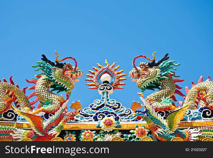 Photo dragon statue chinese style in the sky, no clouds. The Chinese believe that it is a sacred animal has the power and pleasure. Photo dragon statue chinese style in the sky, no clouds. The Chinese believe that it is a sacred animal has the power and pleasure