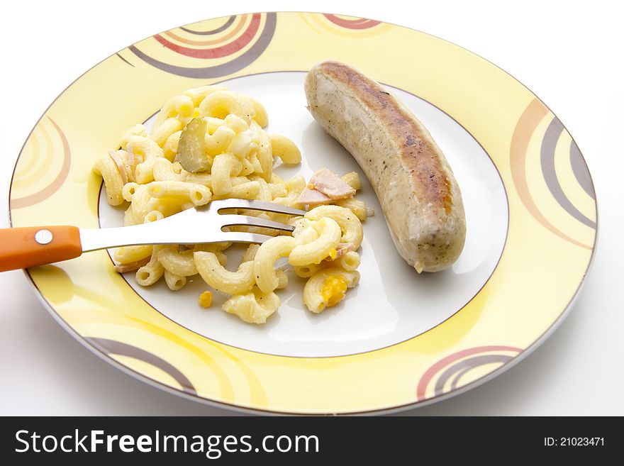 Noodle salad with fried sausage on plate