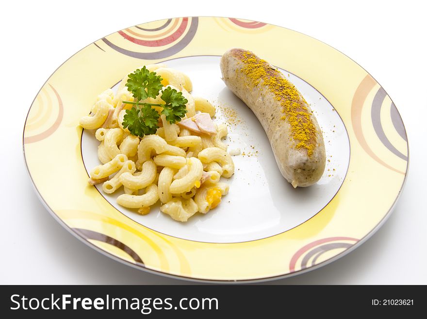 Noodle salad with curry fried sausage on plate