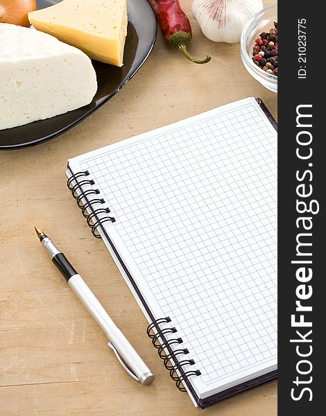 Open notebook cookbook ready for recipe and spices
