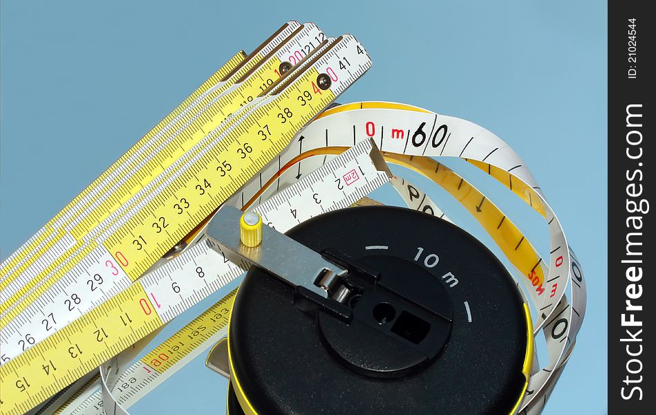 Two measure tools: wooden meter and Tape Measure