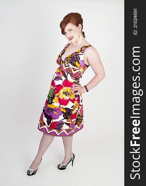 Gorgeous red head model wearing colorful retro dress. Gorgeous red head model wearing colorful retro dress