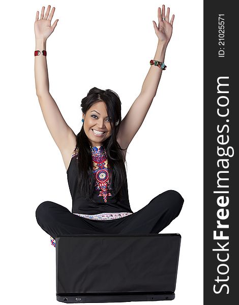 Young Asian woman sitting with arms raised in front of a laptop. Young Asian woman sitting with arms raised in front of a laptop