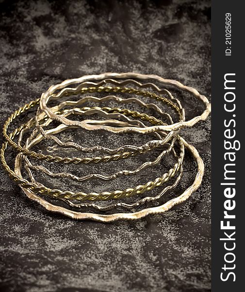 Antique silver bracelets on the stone surface. Antique silver bracelets on the stone surface.