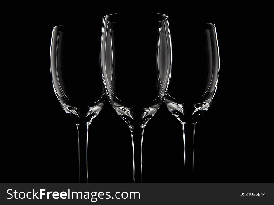 Three elegant black cups in a black background.