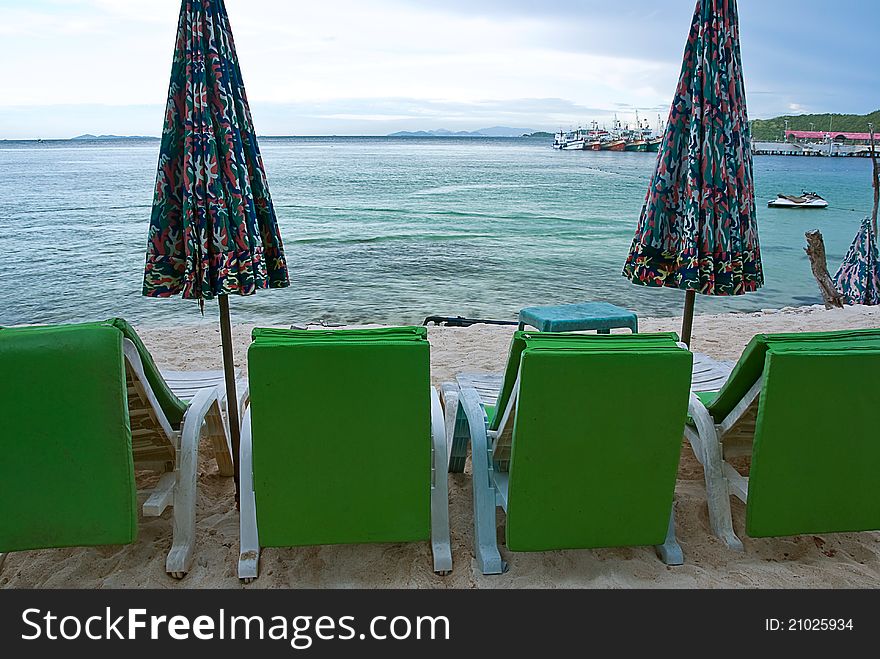 Beach chair and colorful umbrella on the beach , Koh Lan Thailand