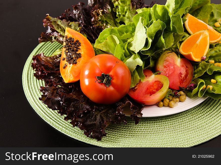 Composition of fruits and vegetables lettuce, orange, tomato, papaya