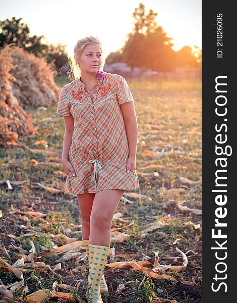 Young woman in corn haystack and sunset. Young woman in corn haystack and sunset