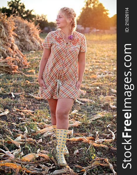 Young woman in corn haystack and sunset. Young woman in corn haystack and sunset