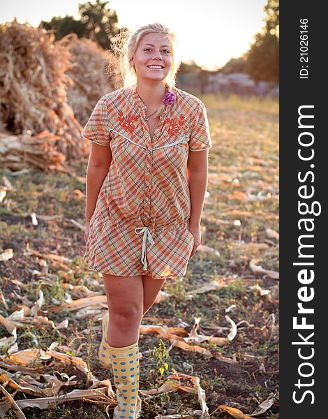 Young woman in corn haystack and sunset. Young woman in corn haystack and sunset