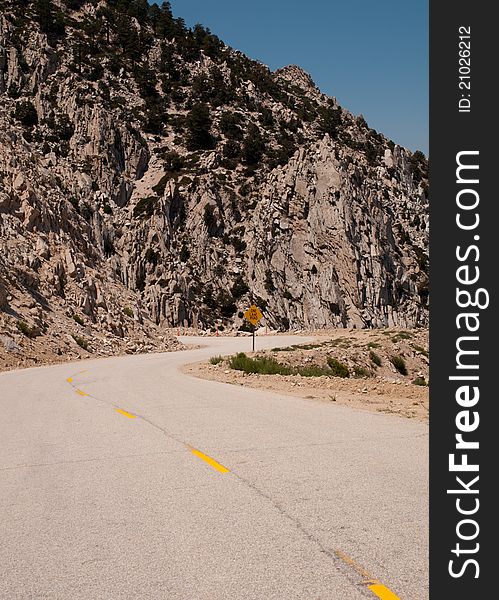 A single narrow windy road passes through the eastern sierra mountains of california. A single narrow windy road passes through the eastern sierra mountains of california.