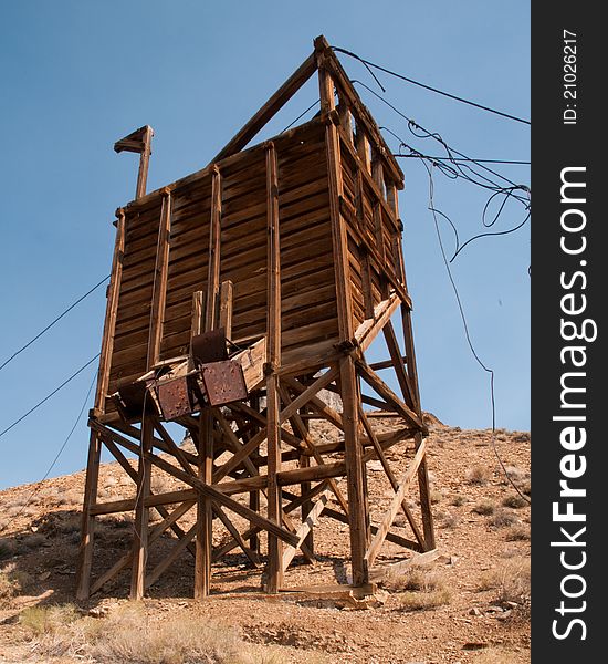 Abandoned mining structure stands tall in the desert. This structure was used to unload ore from and overhead tram bucket. The bucket ran on cables that now lay draped over the structure. Abandoned mining structure stands tall in the desert. This structure was used to unload ore from and overhead tram bucket. The bucket ran on cables that now lay draped over the structure.