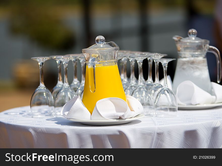 Orange juice and water in jugs at a wedding reception