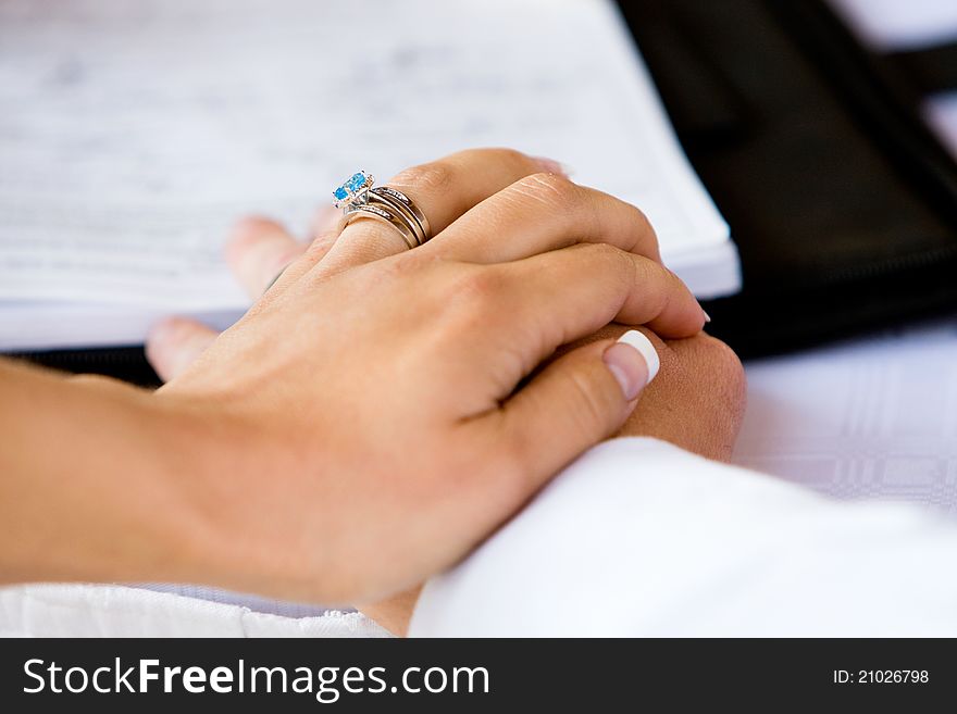 A close up of a bride's hand on the the groom's. A close up of a bride's hand on the the groom's