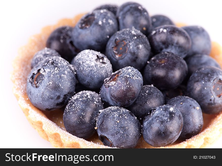 Close up picture of blueberries tart on white background