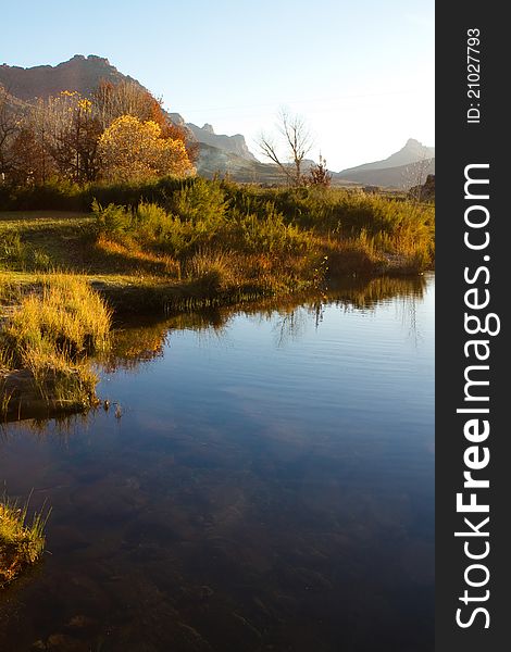 A colorful autumn scene next to a river